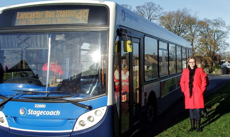 Councillor stood next to bus